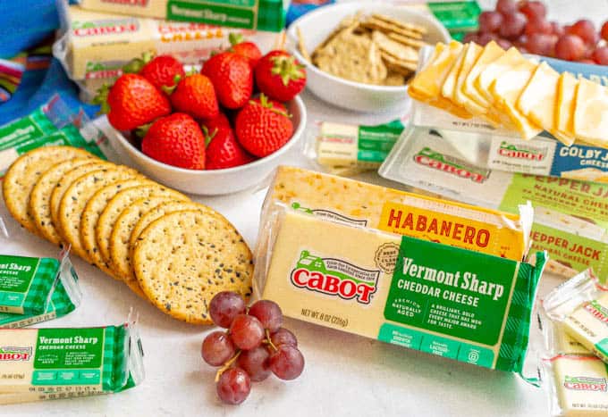 Spread of Cabot cheeses with fresh fruit and crackers