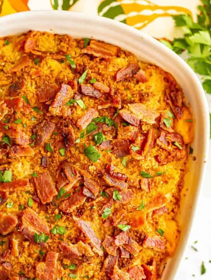 Pumpkin mac and cheese casserole with bacon and parsley on top after baking in the oven