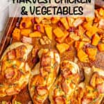 A sheet pan with chicken breasts brushed with mustard and topped with bacon and rosemary alongside sweet potatoes and Brussels sprouts.