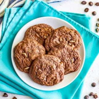 A plate of double chocolate cookies with mint pieces baked in on a white plate
