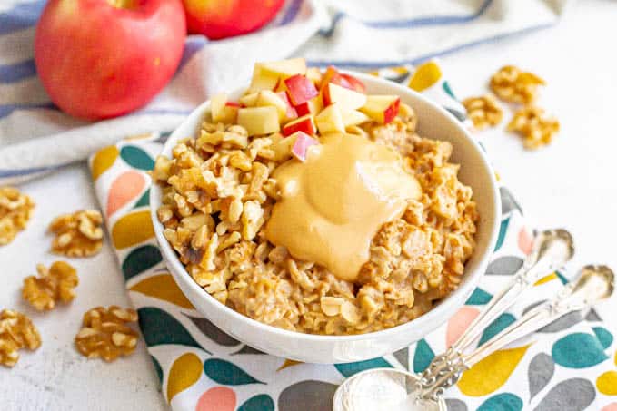 Cooked oatmeal with toppings served in a white bowl