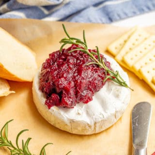 Warm baked brie with cranberry sauce, served with crackers and fresh bread