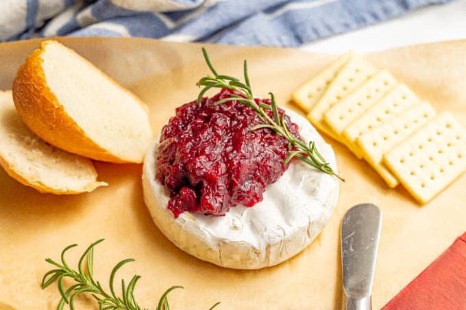 Warm baked brie with cranberry sauce, served with crackers and fresh bread