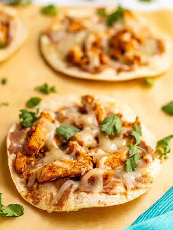Cheesy turkey tostadas on parchment paper after baking in oven