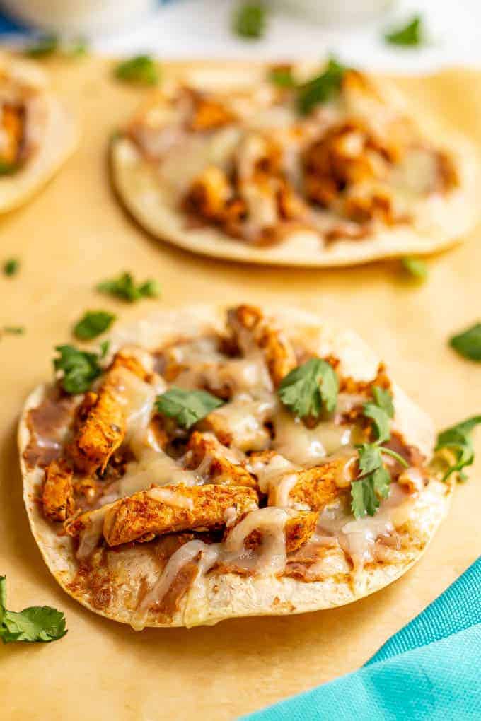 Cheesy turkey tostadas on parchment paper after baking in oven