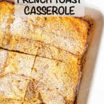 Baked French toast casserole in a white rectangular dish with powdered sugar sprinkled on top and a text overlay on the photo.