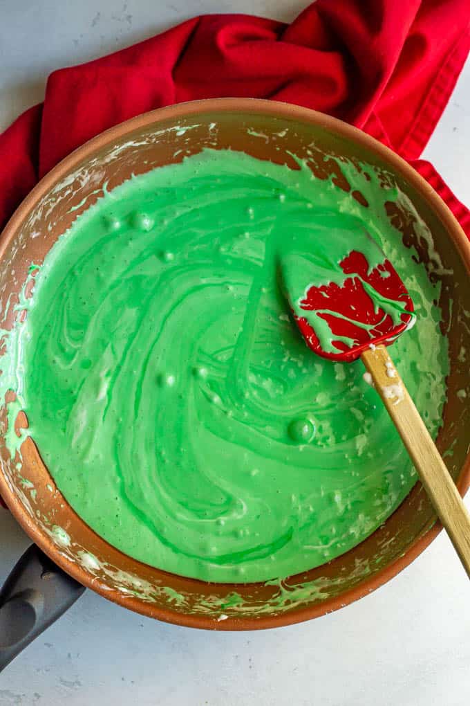 Green colored melted marshmallows in a copper pan