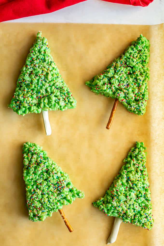 Rice Krispies Christmas trees on a piece of parchment paper