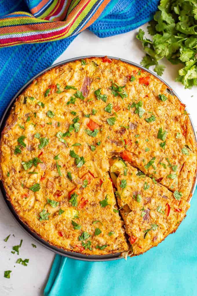 A baked egg frittata with chicken and vegetables topped with chopped cilantro