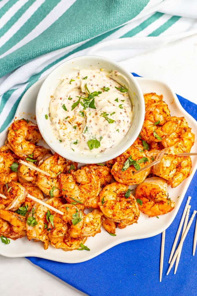 White serving tray with roasted shrimp and a creamy dip