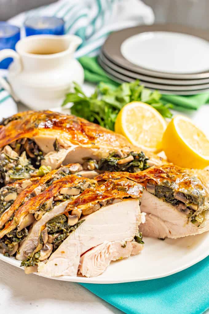 A roasted sliced stuffed turkey breast with spinach and mushrooms,