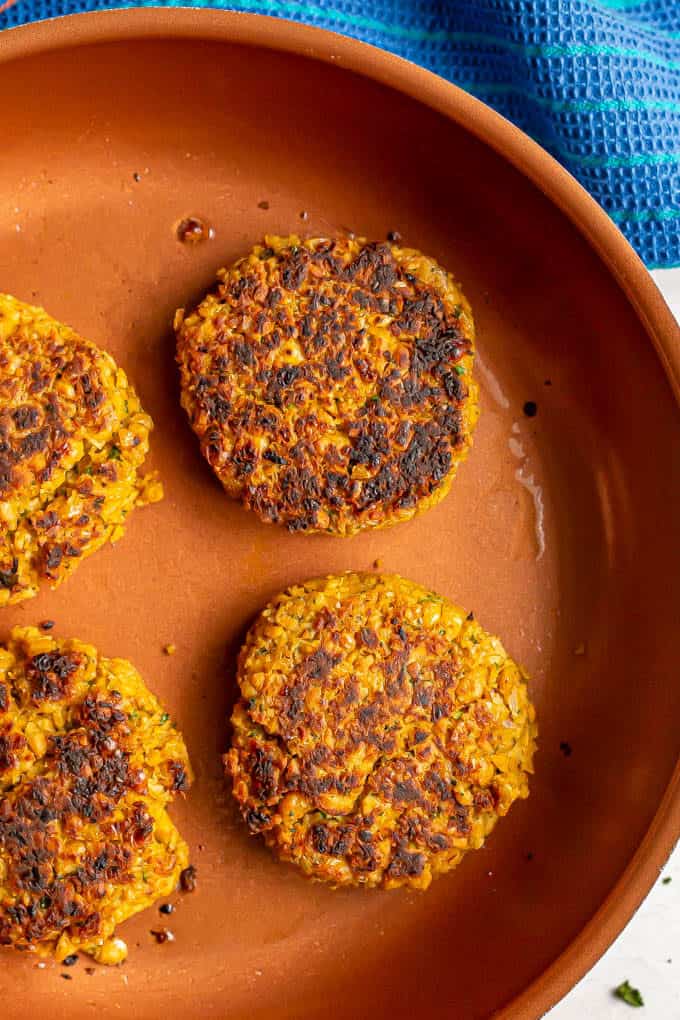 Easy chickpea burgers being cooked in a pan