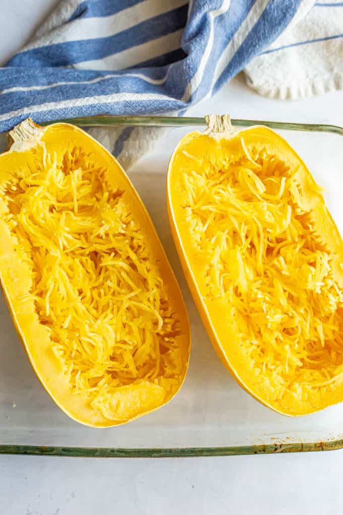 Microwave spaghetti squash halves after cooking and being pulled into strands