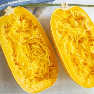 Microwave spaghetti squash halves after cooking and being pulled into strands