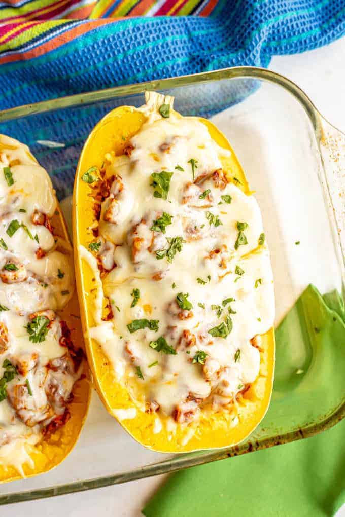 Chicken enchilada spaghetti squash with melted cheese in a casserole dish after baking