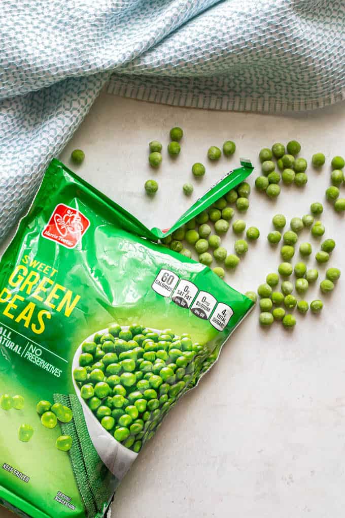 Frozen peas spilling out of a bag