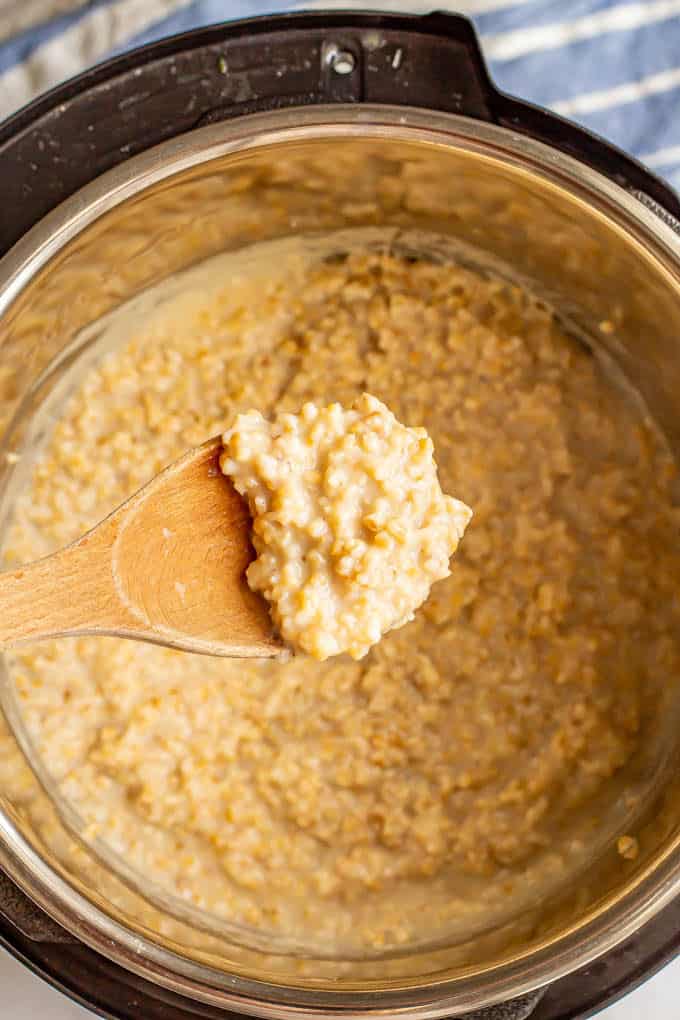 Spoonful of steel cut oatmeal being lifted out of the Instant Pot