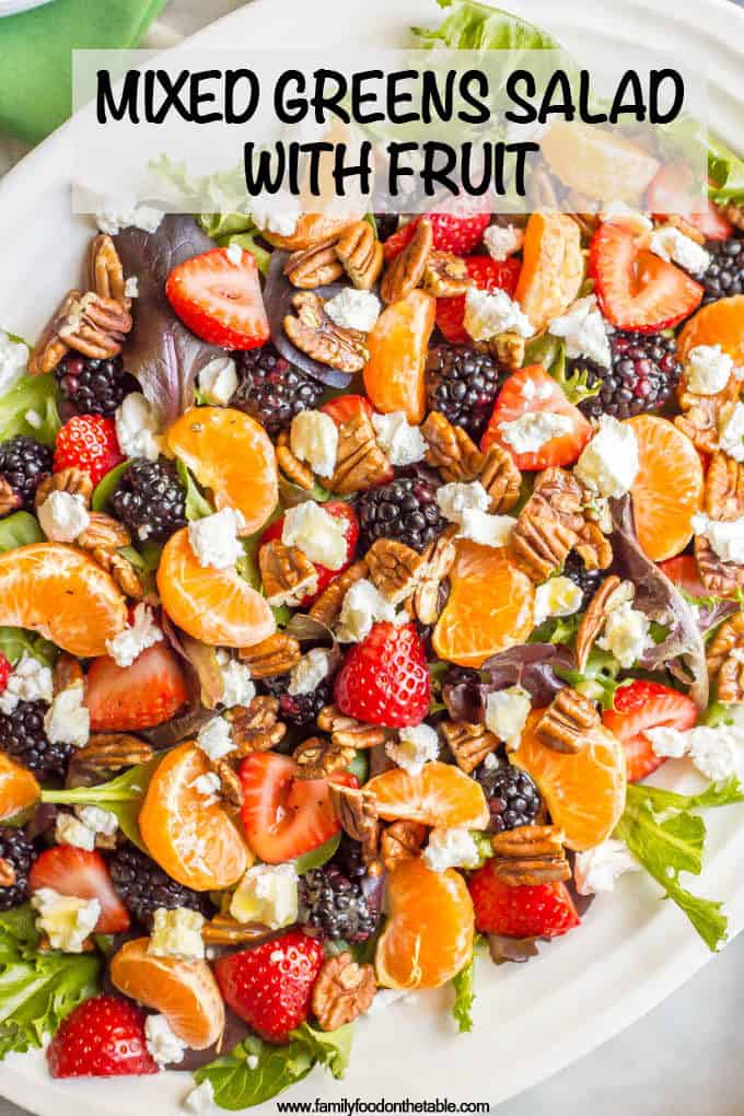 This mixed greens salad with fruit, goat cheese and nuts is perfect for a beautiful side dish or brunch spread! It comes together quickly and is finished with a super easy honey-lime vinaigrette. #brunchsalad #brunch #greensalad #saladlover