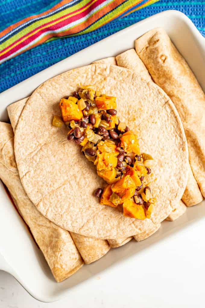 Tortilla with sweet potatoes and black beans as a filling for enchiladas