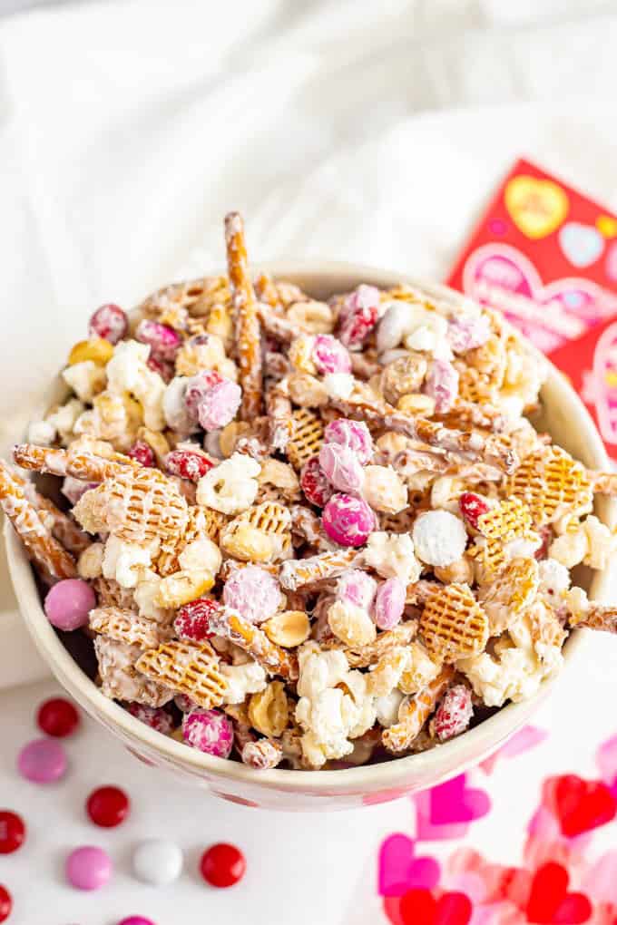 A Valentine's Chex mix with cereal, pretzels, popcorn and red, pink and white M&Ms