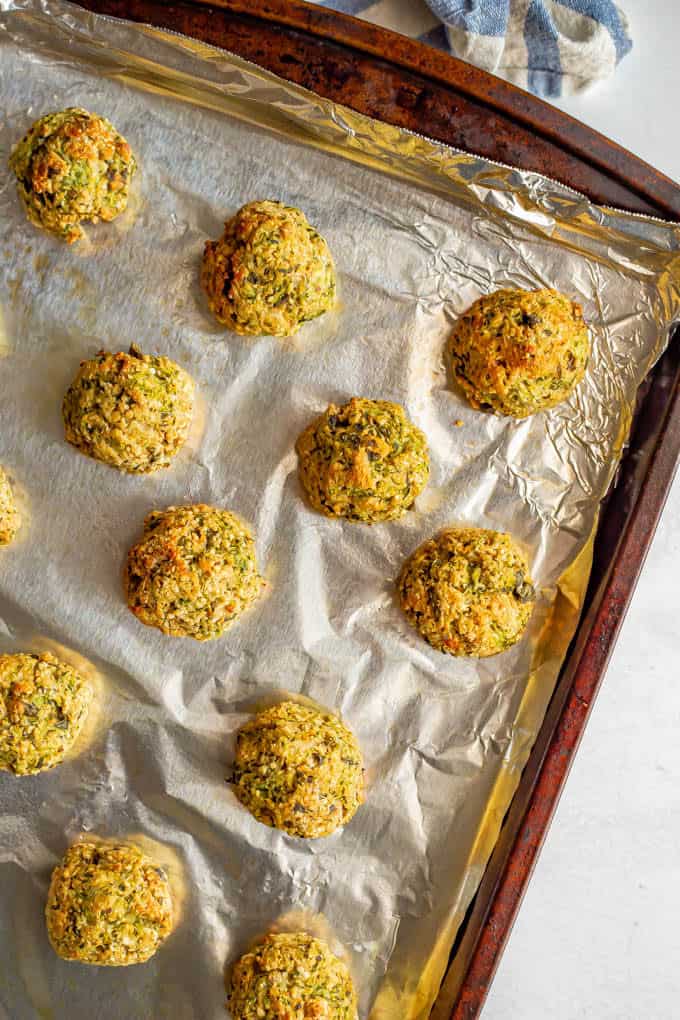 Baked zucchini meatballs on a foil-lined sheet pan