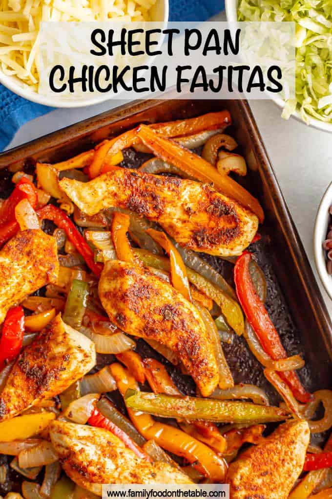 Sheet pan chicken fajitas with bell peppers and onions and nearby bowls of toppings with a text box at top