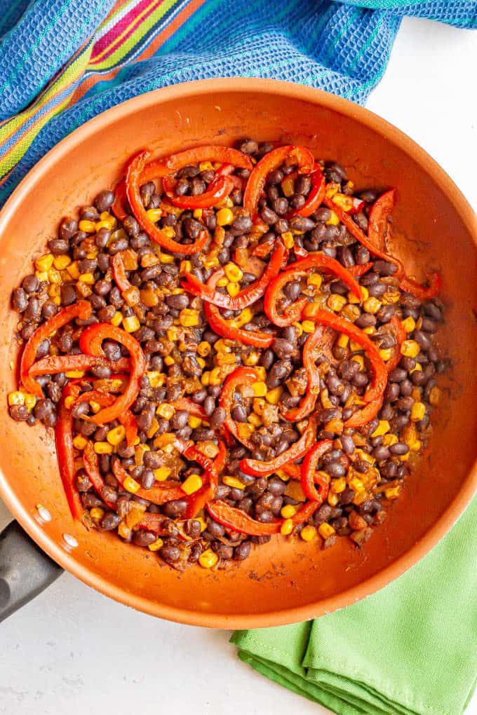 Black beans, red pepper and corn cooked in a copper skillet