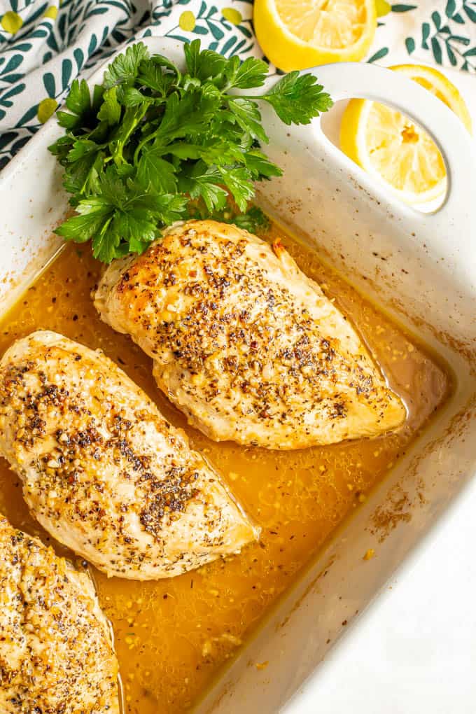 Seared and baked lemon chicken breasts in a lemon sauce in a casserole dish