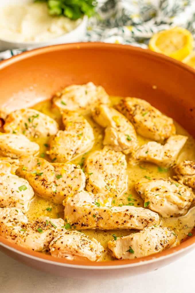 Strips of chicken breasts in a lemony sauce in a copper skillet
