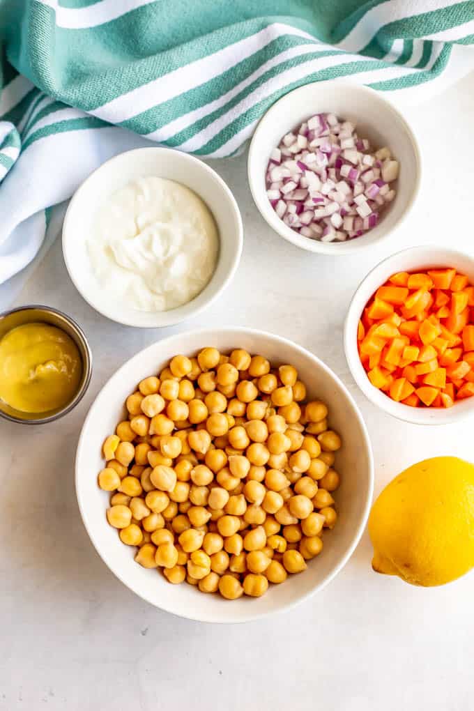 Separate bowls of ingredients laid out on a white marble counter