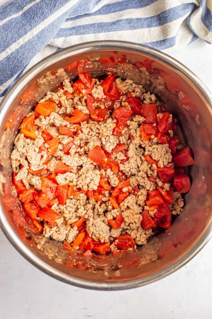 Cooked ground turkey and diced tomatoes in an Instant Pot