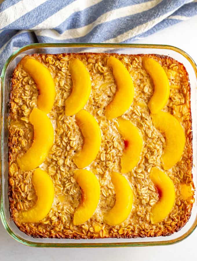 Baked oatmeal with peaches in a glass baking dish after coming out of the oven