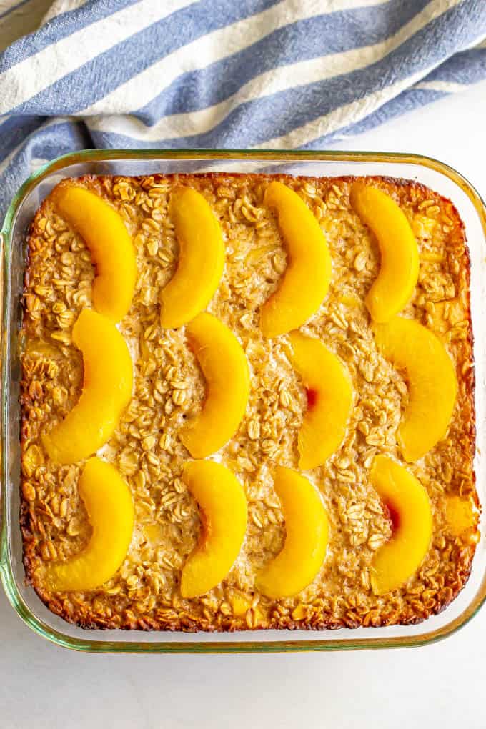 Baked oatmeal with peaches in a glass baking dish after coming out of the oven