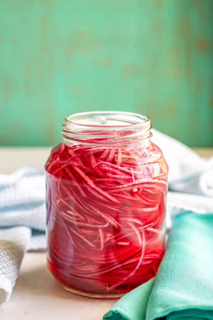 A large jar of homemade pickled red onions ready to use