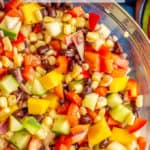 A colorful mixed salad of black beans, mango and veggies