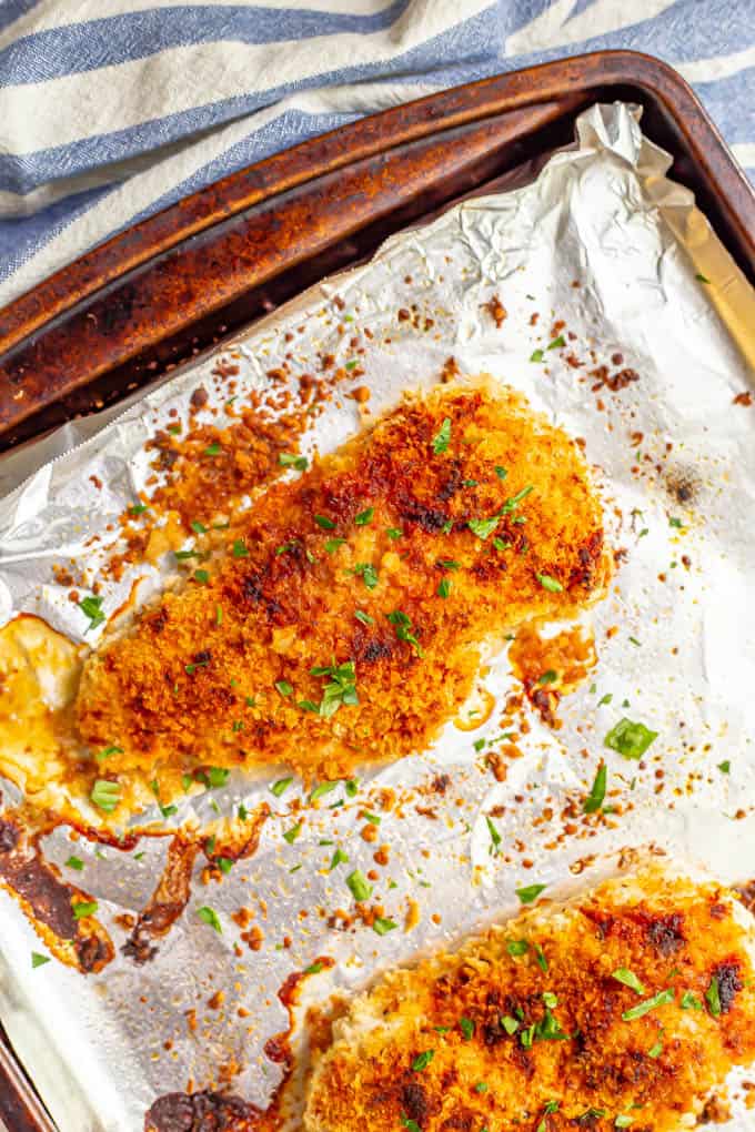 Crunchy golden brown chicken breasts on a sheet pan after baking