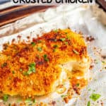 Crunchy golden brown chicken breasts sprinkled with chopped parsley on a sheet pan after baking with a text box