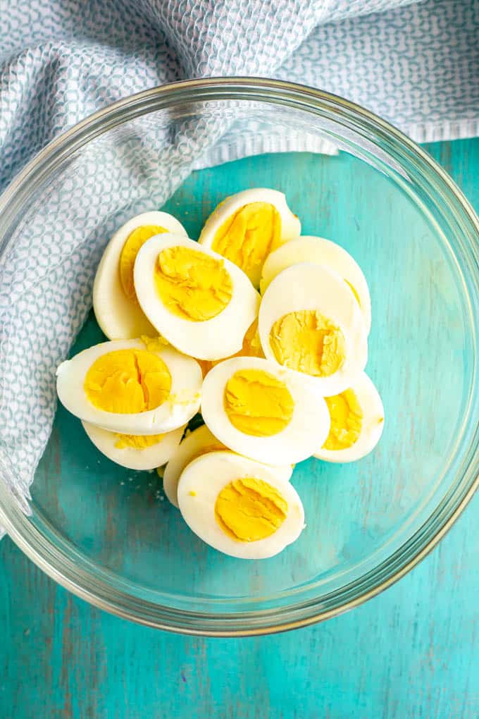 Halved hard boiled eggs in a large glass bowl