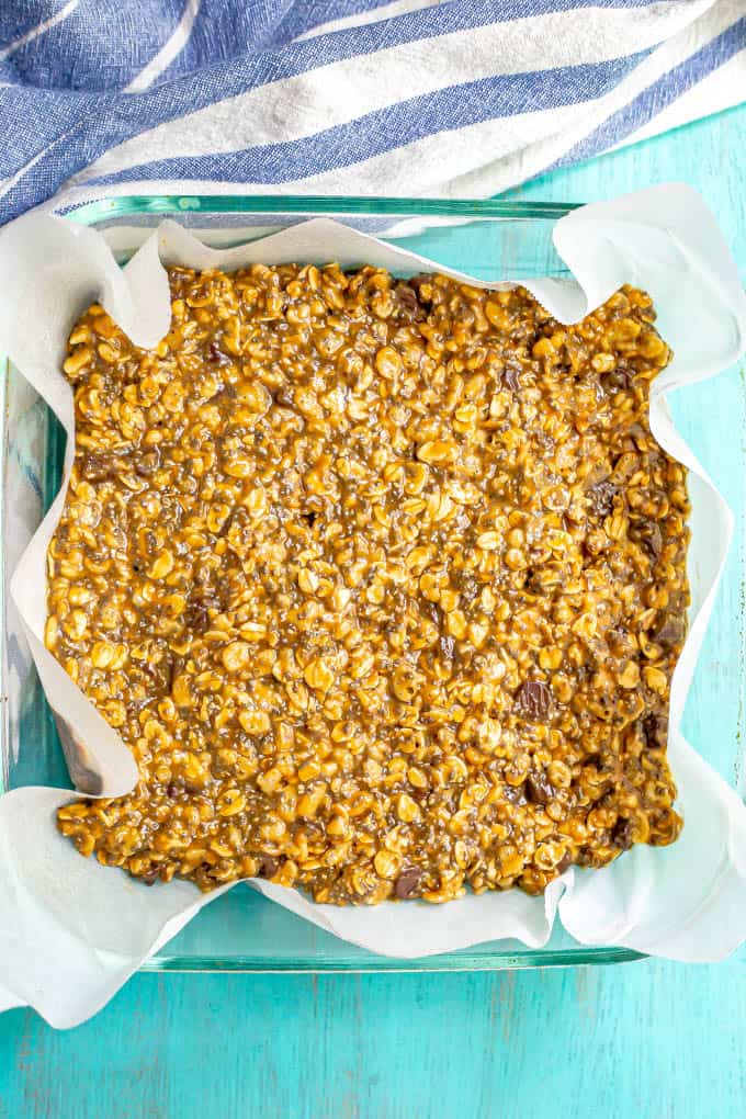 Healthy no bake granola bars in a square glass pan before being sliced