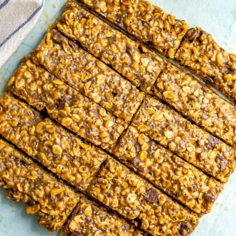 Healthy granola bars with chocolate chips, chia seeds and oats on a piece of parchment paper
