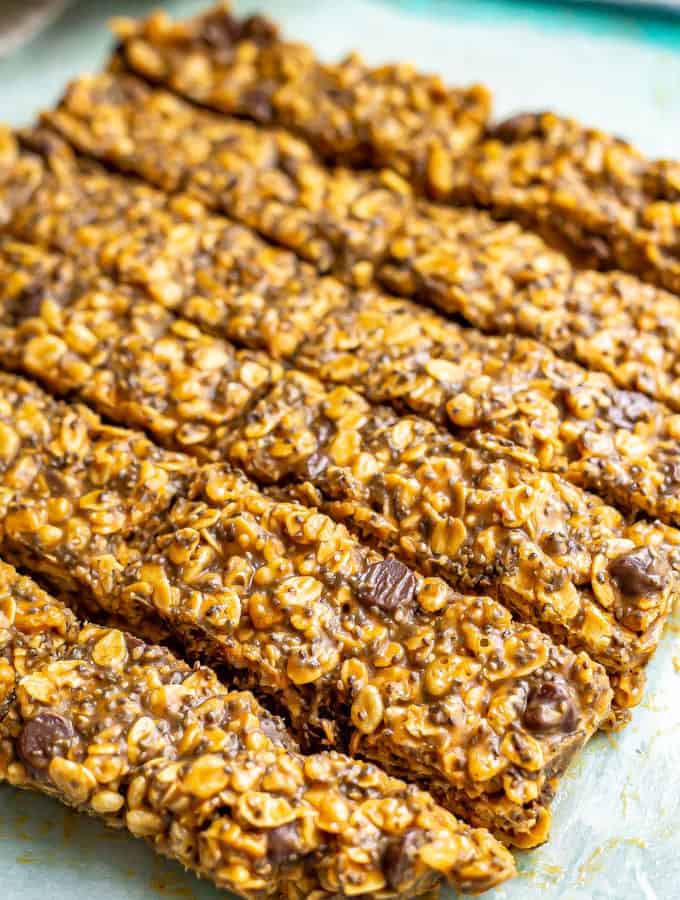 Homemade healthy granola bars cut into slices on a pice of parchment paper