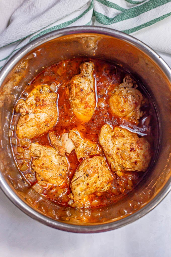 Cooked chicken thighs in a lemony sauce in an Instant Pot