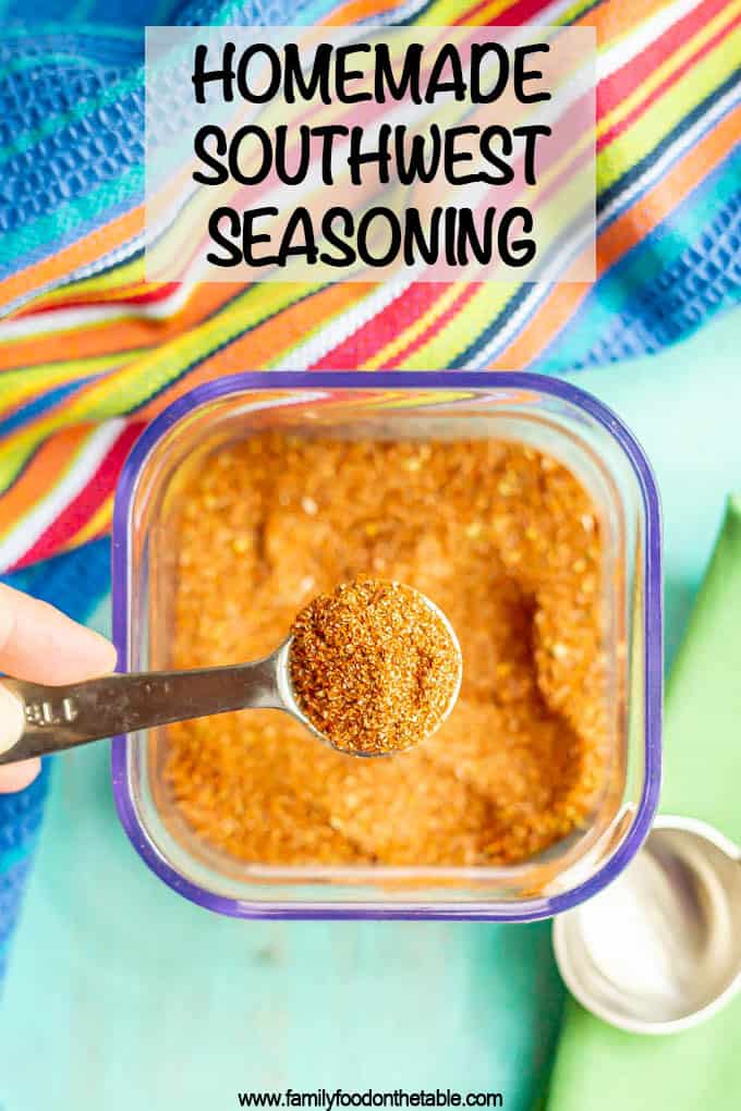 A teaspoon measure scooping up some southwest seasoning out of a clear container with a text overlay on the photo