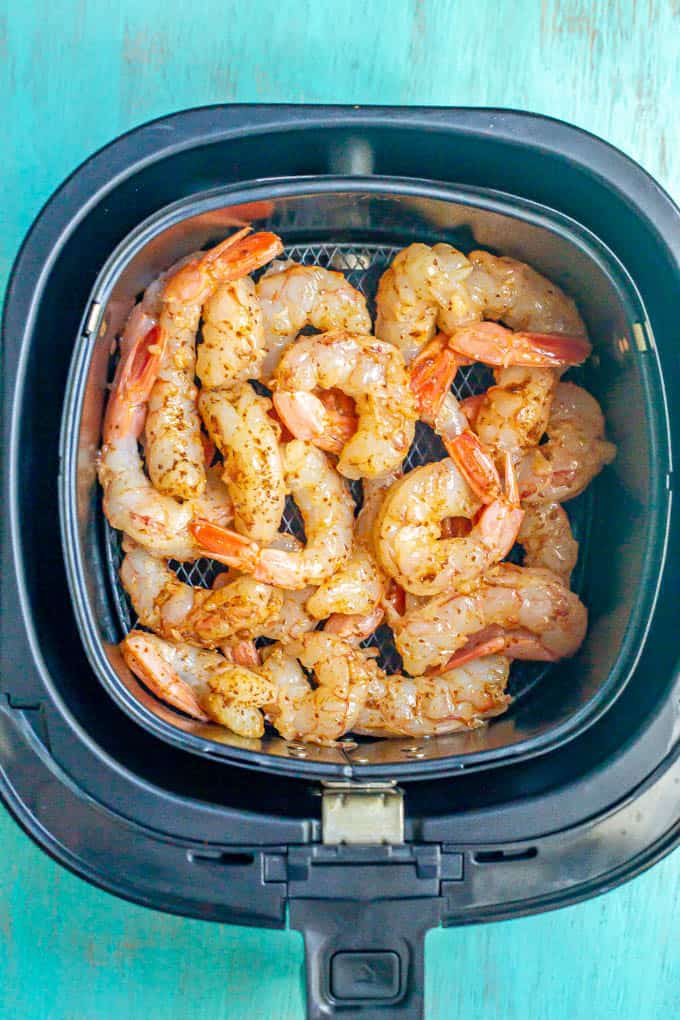 Raw shrimp in the tray of an Air Fryer before being cooked