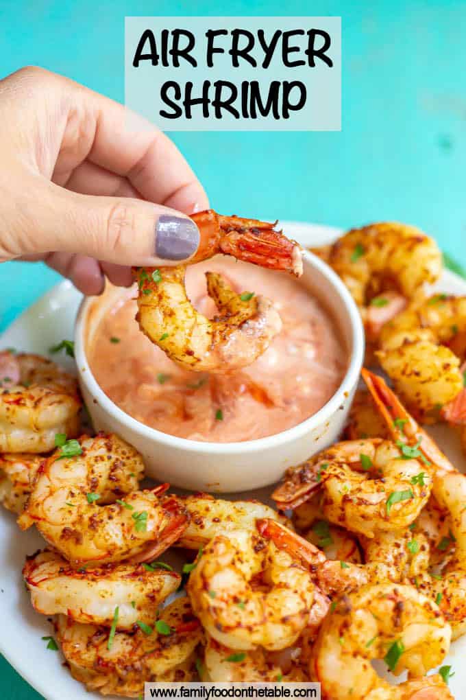 A hand dipping a shrimp into a creamy salsa with a text overlay on the photo
