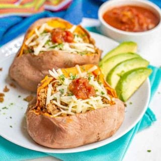 Sweet potatoes with taco fillings on a white plate