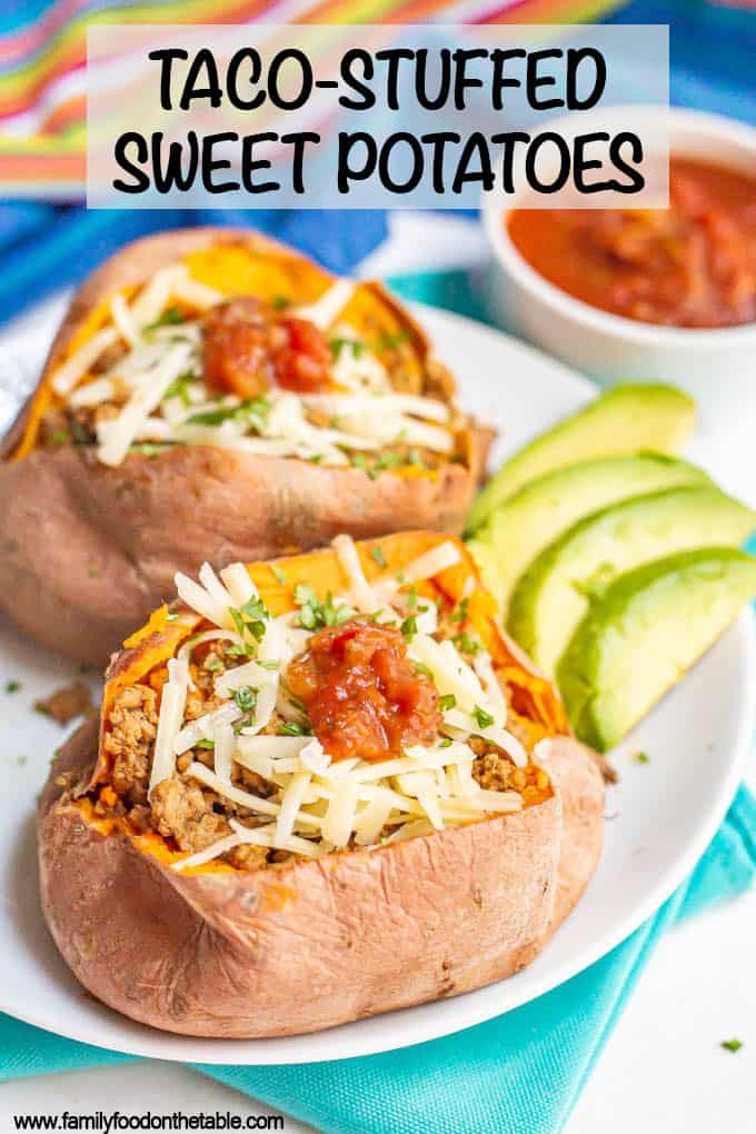 Two sweet potatoes stuffed with ground taco meat and topped with cheese and toppings plus a text overlay