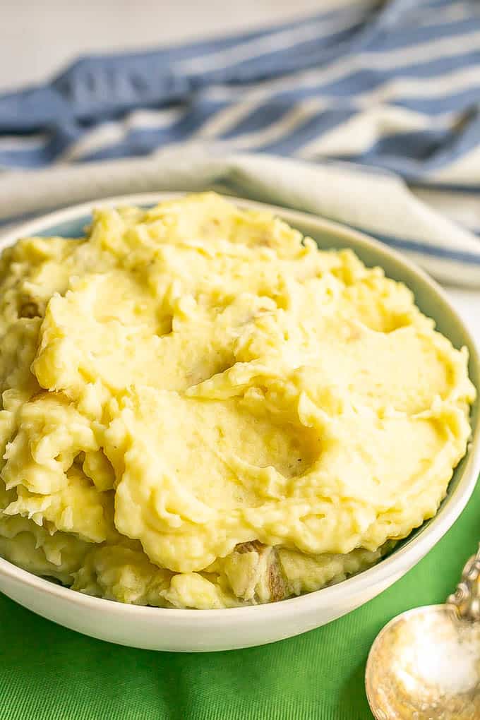 Close up of creamy Yukon mashed potatoes in a blue and white serving bowl