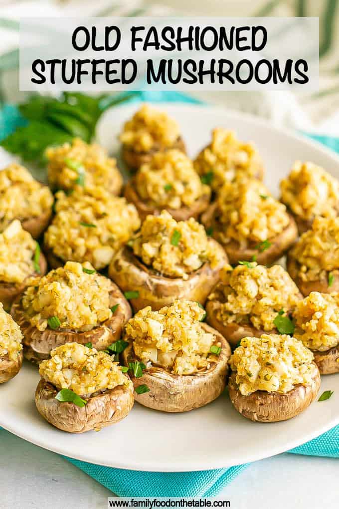 Stuffed mushrooms sprinkled with parsley and served on a white plate with a text overlay on the photo