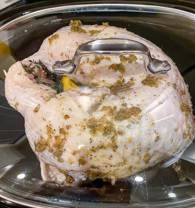 A raw bone in turkey breast in a slow cooker before being cooked